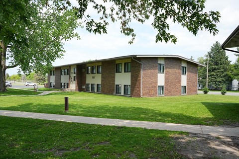 A building with a green lawn in front of it.