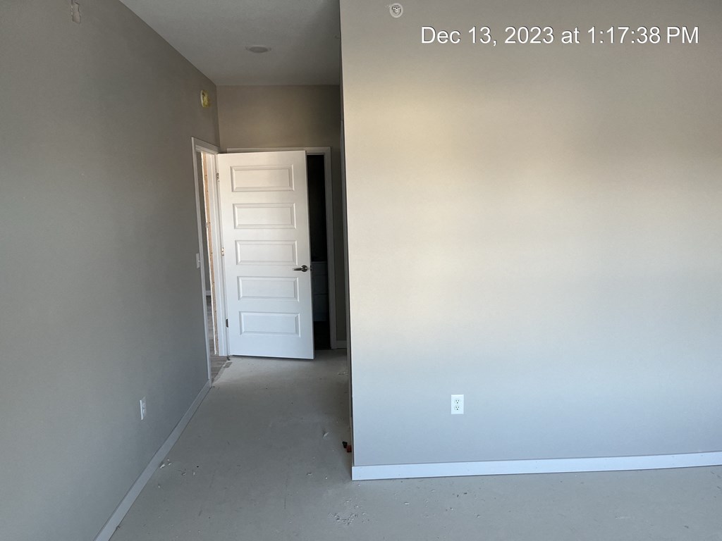 the interior of a house with white walls and a white door