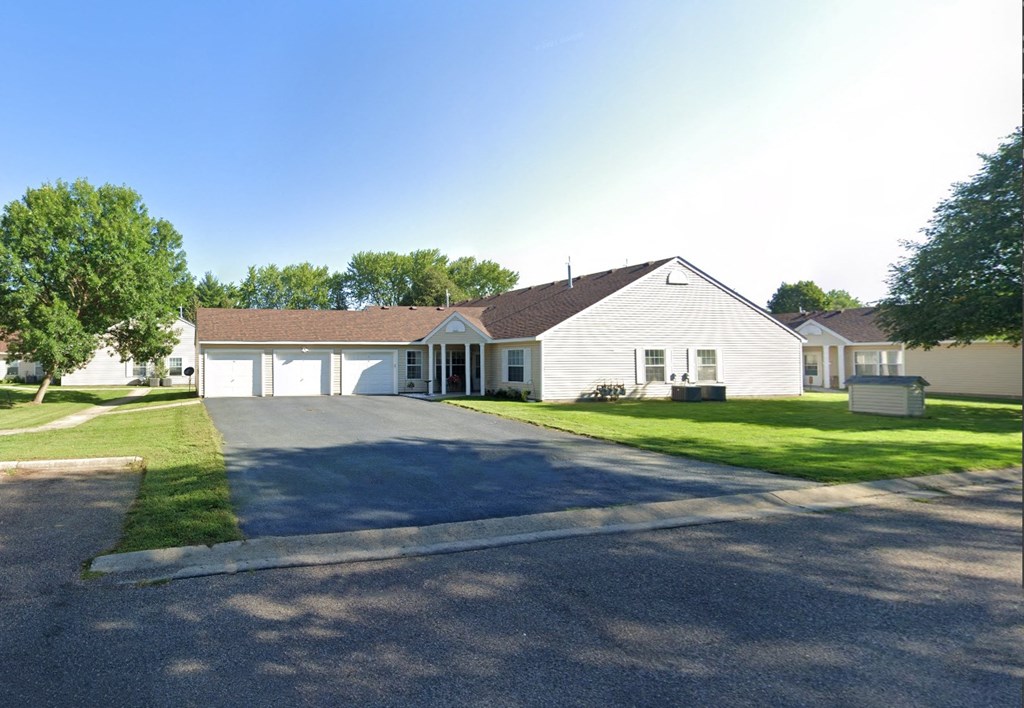 a white house with a driveway and a garage door
