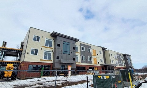 a row of apartment buildings being constructed in the snow
