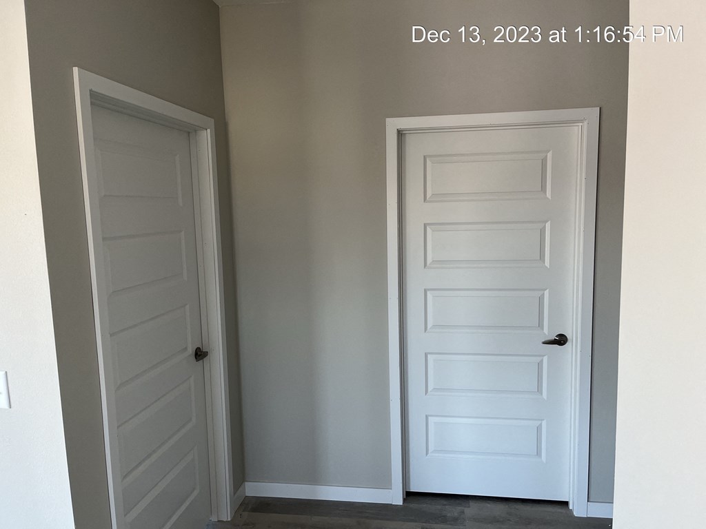 the closet door is closed and the door to the next room is open