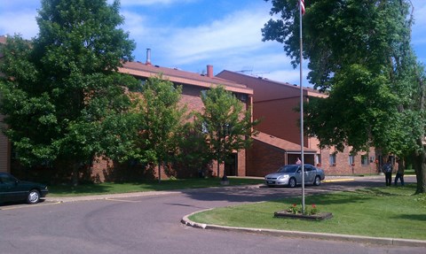 A building with a flag on a pole in front of it.