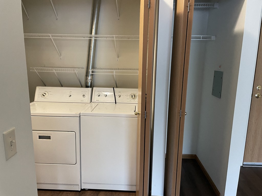 an empty laundry room with a washer and dryer