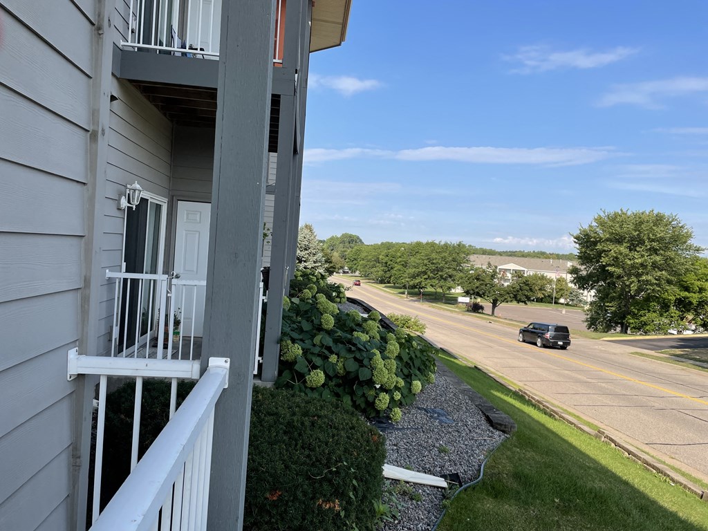 a balcony with a view of a street and a building