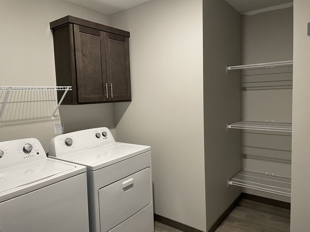 a laundry room with a washer and dryer and a closet