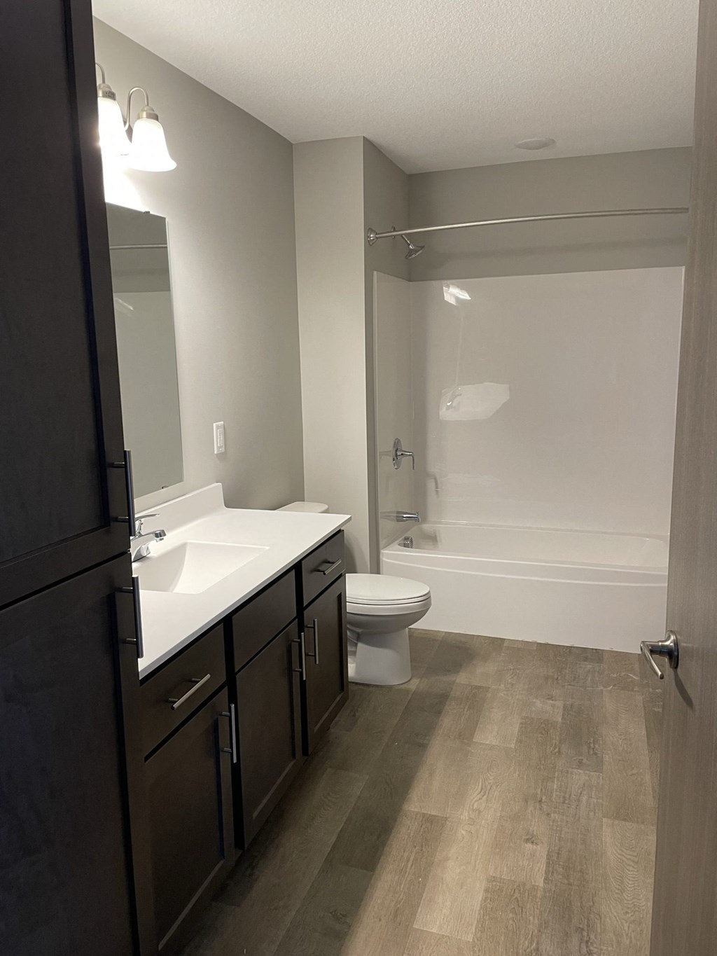 a bathroom with a sink and a toilet and a shower