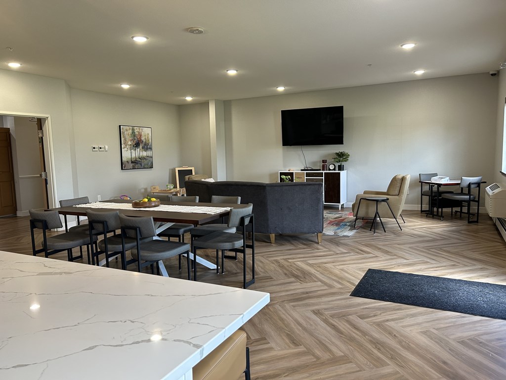 A modern dining room with a large table and chairs.