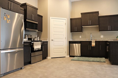 a kitchen with stainless steel appliances and black cabinets