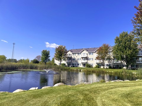 A large white building with a fountain in front of it.