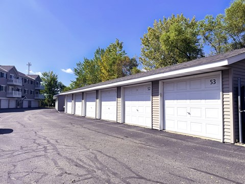 A row of white garage doors are numbered 53 and 52.