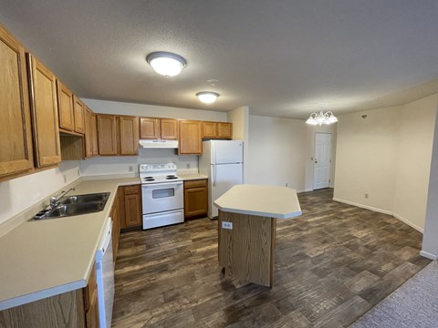 A kitchen with wooden cabinets and a white refrigerator.