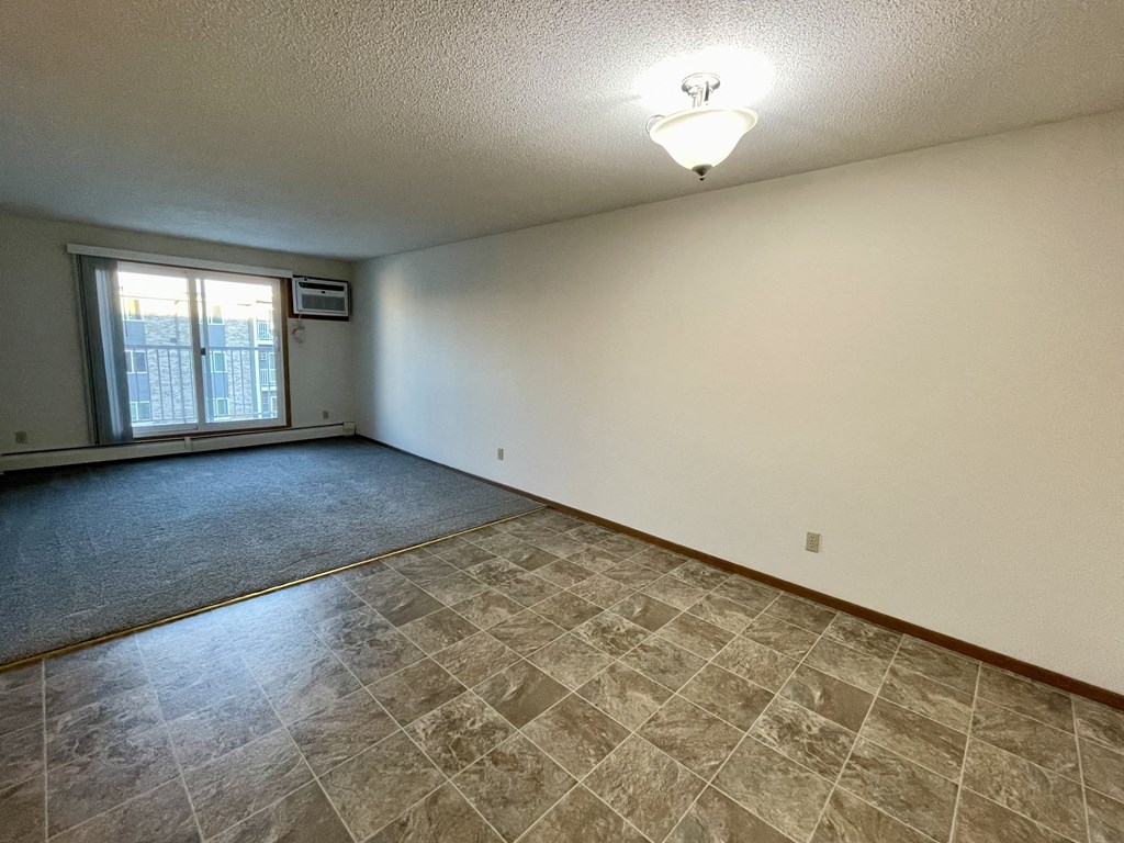A room with a tiled floor and a window.