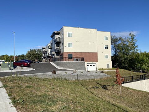 an apartment building with a car parked in front of it