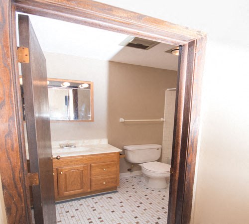Bathroom with large vanity, toilet, and shower