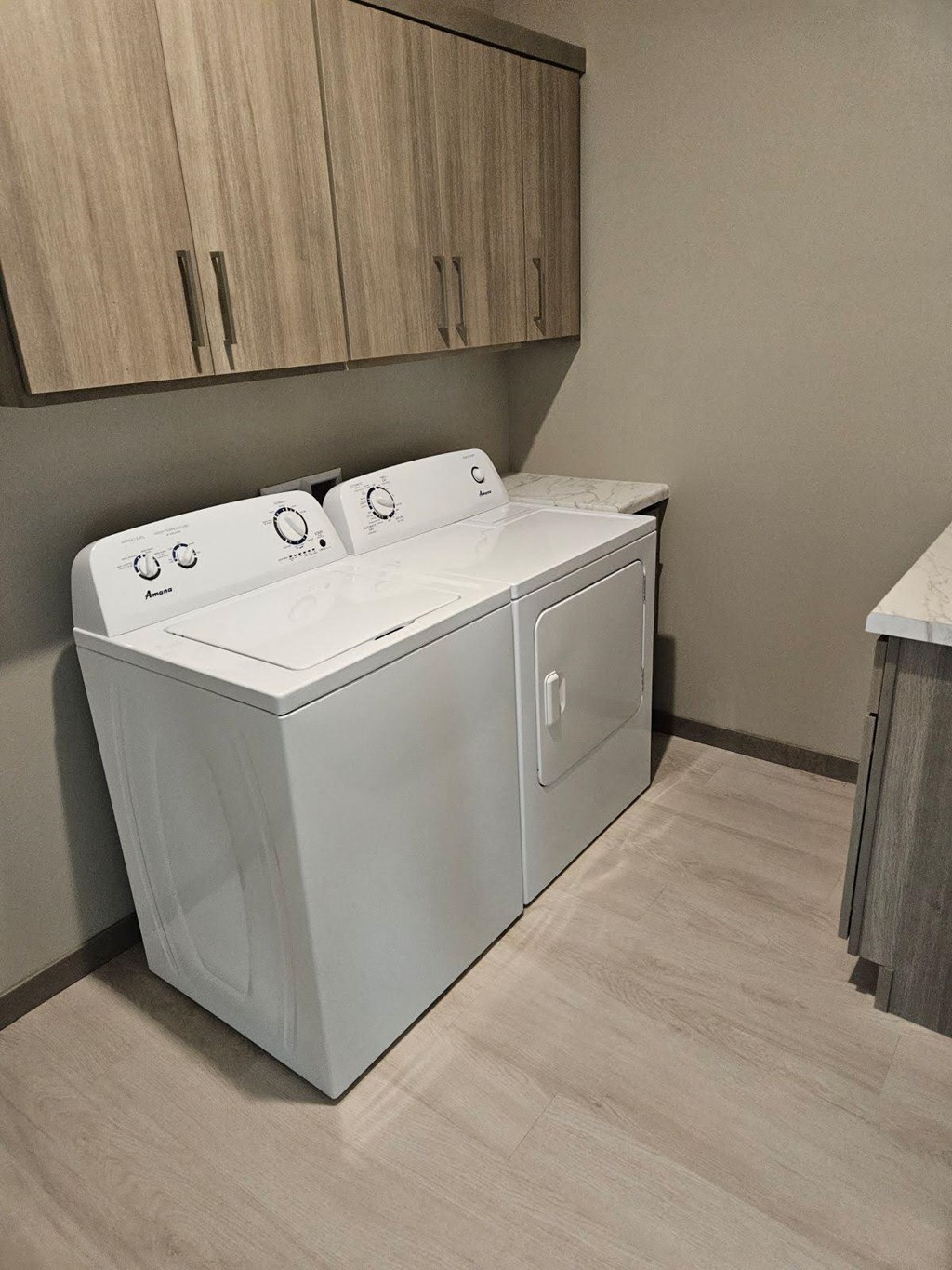 A white washing machine in a laundry room.
