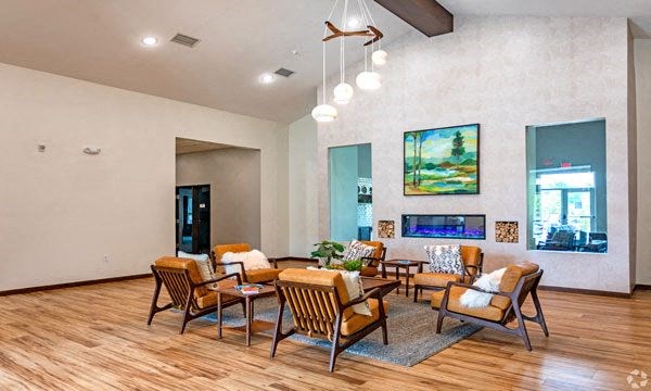 a living room with a table and chairs and a fireplace