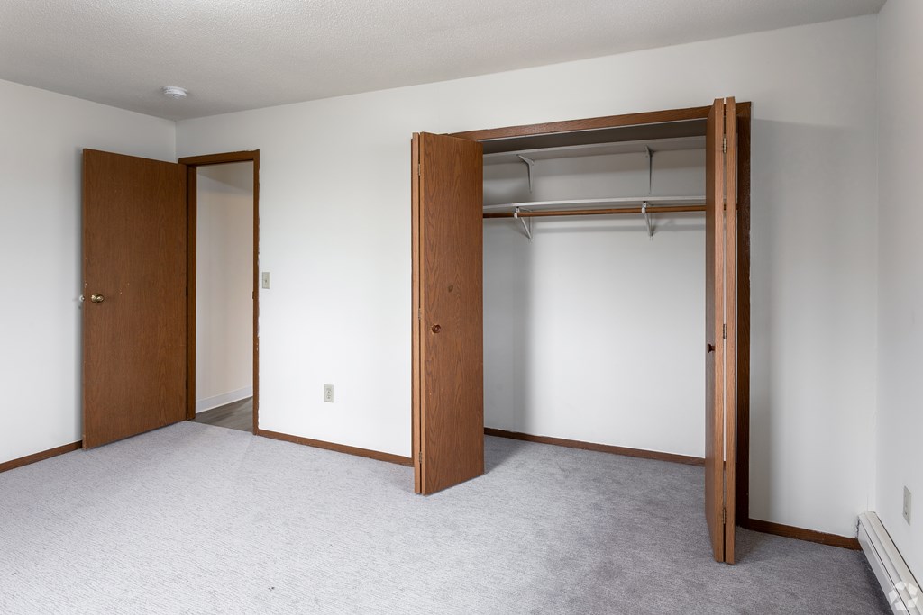 BLDG B/D - A room with a closet and a door.