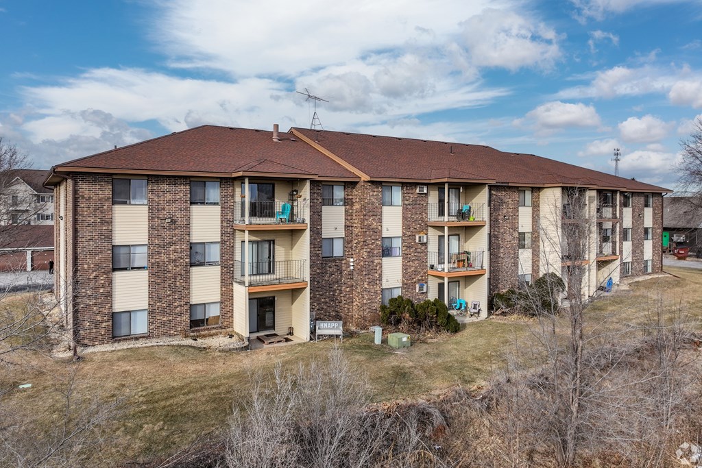 BLDG B - A large apartment complex with a grassy area in front.