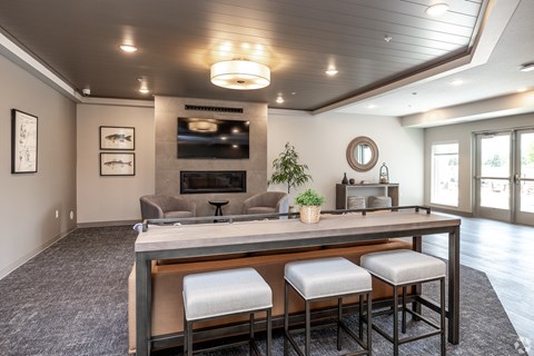 A modern dining room with a long table and chairs.