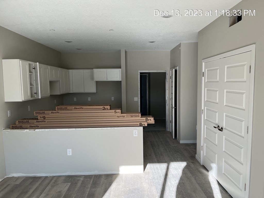 the interior of a living room with white cabinets and a counter