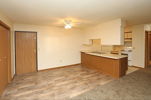 A kitchen area with a sink, stove, and oven.