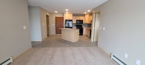 a room with a kitchen and a counter in the middle