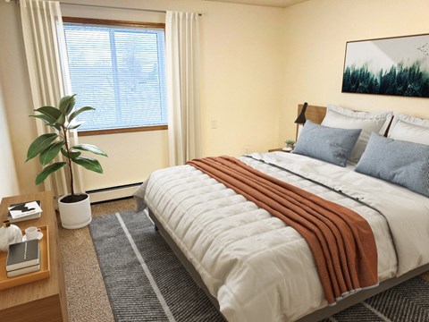 A bedroom with a large bed and a potted plant.