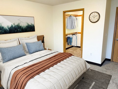 A bedroom with a large bed and a wardrobe.