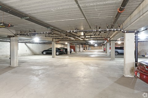 A large, empty parking garage with concrete floors and multiple columns.