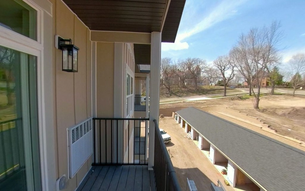 a view from a balcony of a house with a long porch