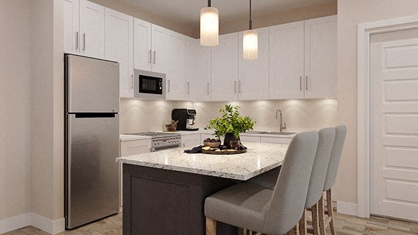 a kitchen with white cabinets and a marble counter top