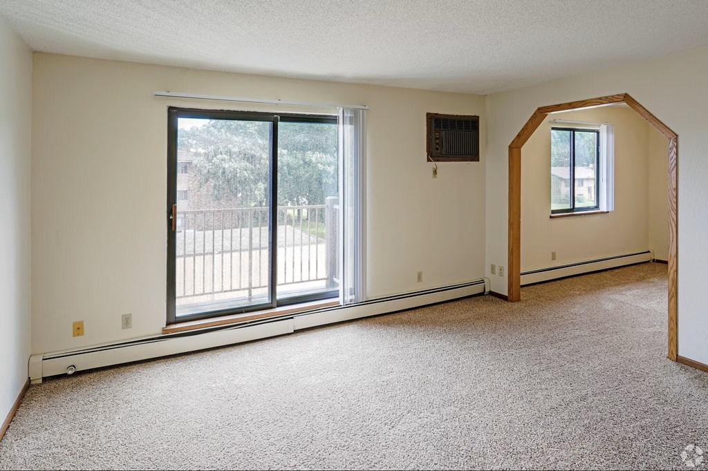 A room with a window and sliding glass doors.