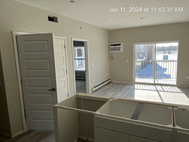 an empty kitchen in an empty house with an open door