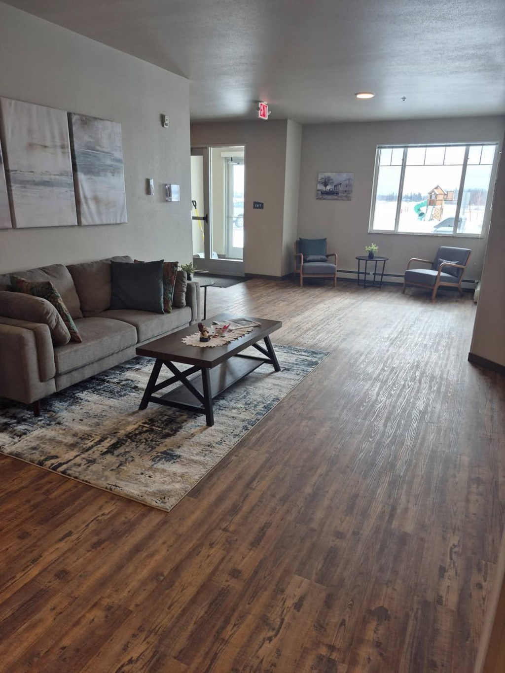 A living room with a couch, chairs, and a coffee table.