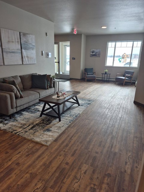 A living room with a couch, chairs, and a coffee table.