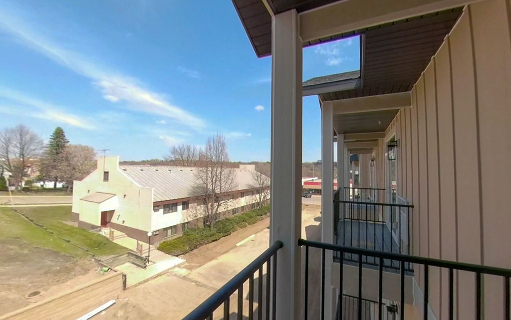 a balcony with a view of a building and a street