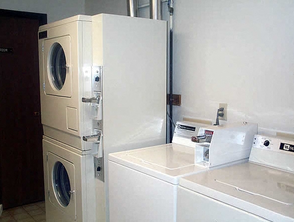 a kitchen with a washing machine and a refrigerator