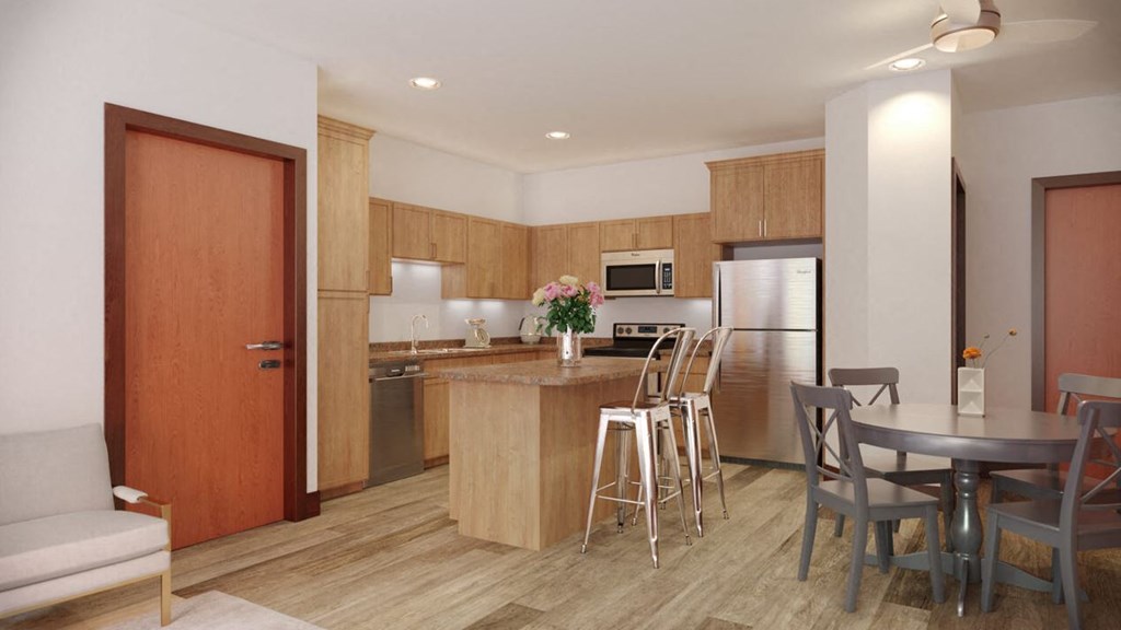 a kitchen and dining room with a table and chairs