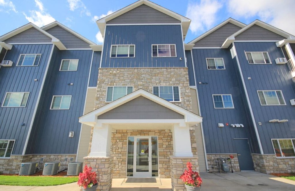 an image of a building with blue siding and a stone facade