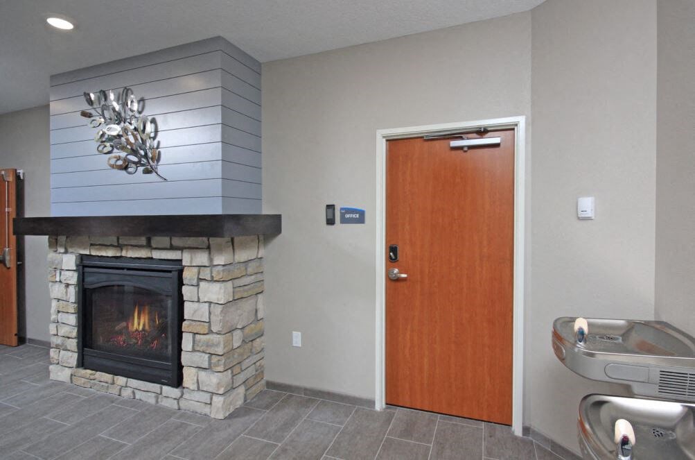 a living room with a fireplace and a wooden door