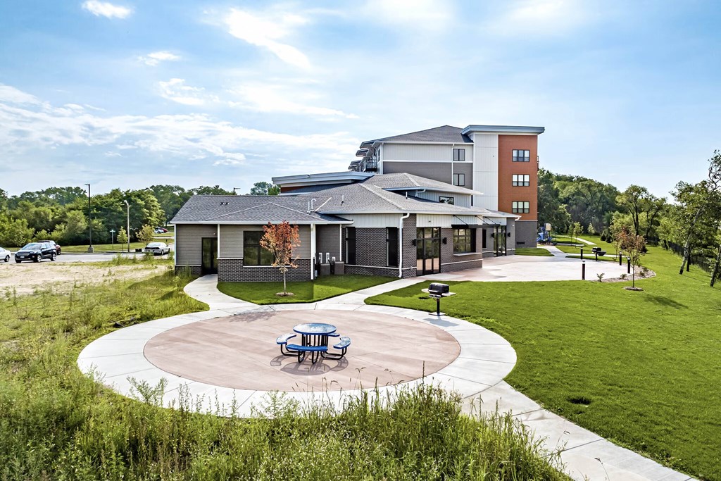 exterior of Golden Aspen flats including paved pat with grill