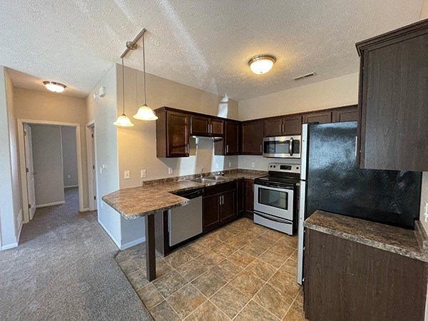 a kitchen with a counter top and a refrigerator