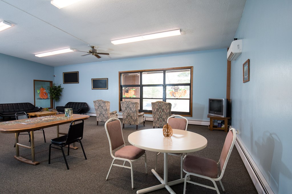 A room with a table and chairs in it.