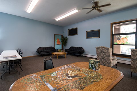 A living room with a jigsaw puzzle on the table.