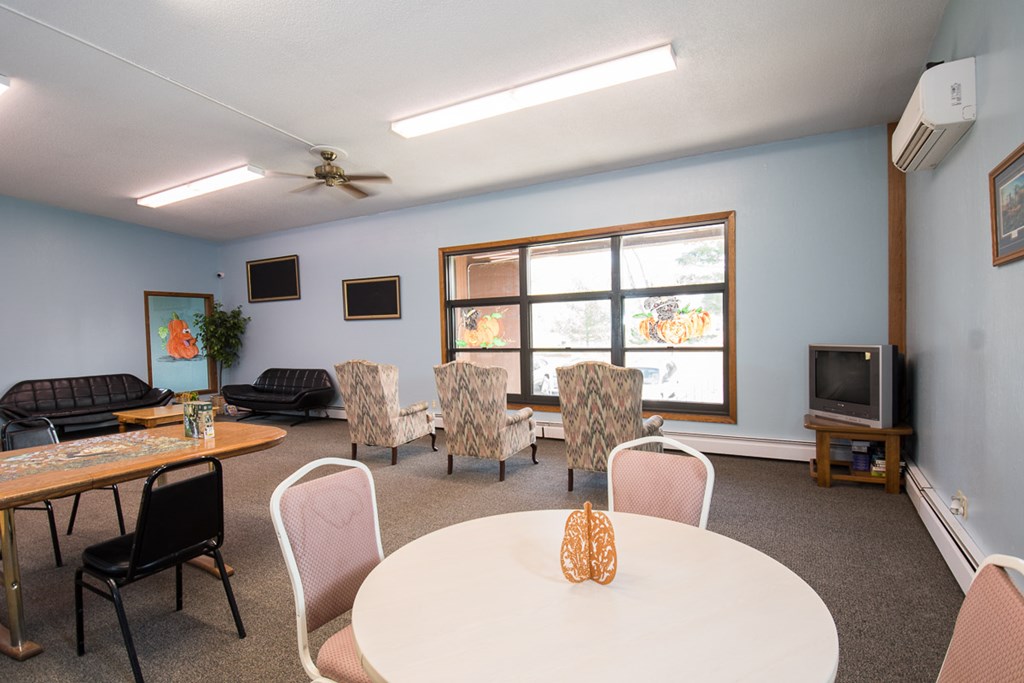 A room with a table and chairs in it.