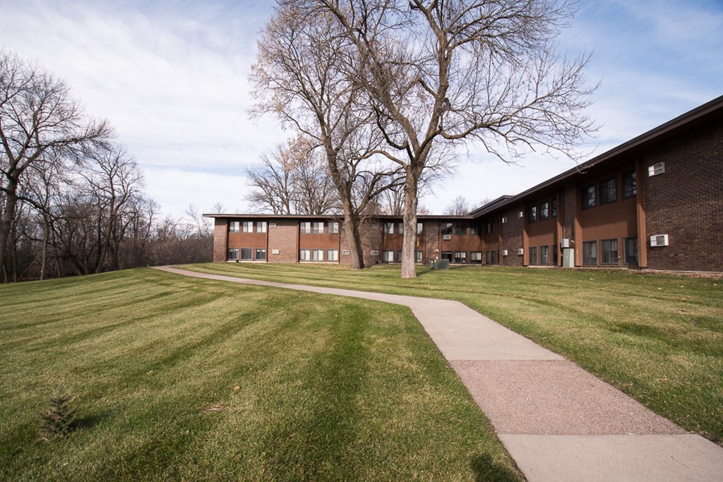 A long building with a walkway in front of it.