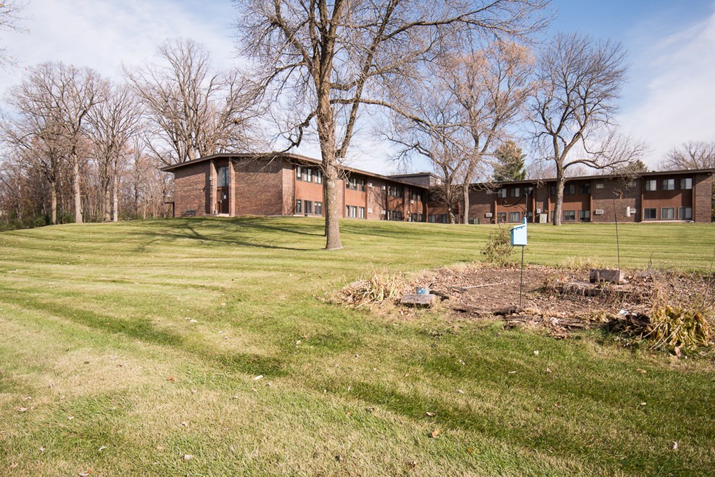 A building with a green lawn in front of it.