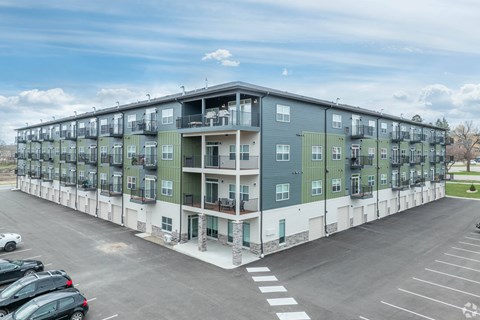 a large apartment building in a parking lot