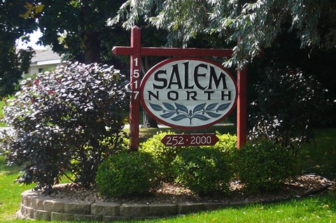 A sign for Salem North with a red cross on it.