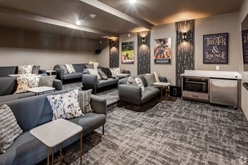 a living room with couches and chairs and a tv